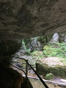 Wanderweg unter Felsüberhang in der Twannbachschlucht mit Blick in die Schlucht