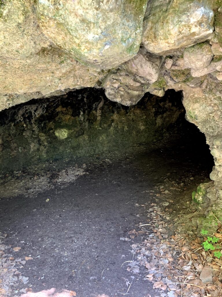 Kleine Höhle am Glütschbach bei Thun mit feuchtem Boden und Felsdecke